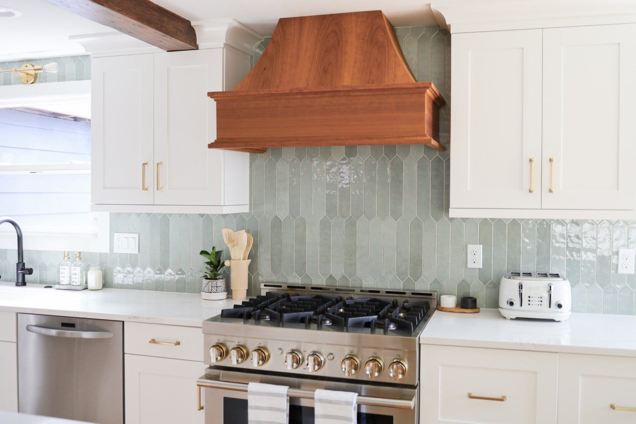 Calacatta Arno countertops with green tile backsplash